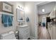 Bathroom with a white vanity, framed mirror and a blue bath towel at 199 Black Cloud Dr, Louisburg, NC 27549
