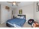 Cozy bedroom with ceiling fan, closet, and sports-themed decor at 199 Black Cloud Dr, Louisburg, NC 27549