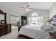 Elegant bedroom with a large arched window, vaulted ceiling, and access to a sunroom at 199 Black Cloud Dr, Louisburg, NC 27549