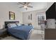 Bedroom featuring a blue bed, ceiling fan, and dresser with sports decor at 199 Black Cloud Dr, Louisburg, NC 27549
