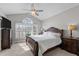 Serene bedroom with a large window, vaulted ceiling, and elegant furniture at 199 Black Cloud Dr, Louisburg, NC 27549