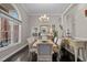 Elegant dining room featuring dark wood floors, large window and stylish decor at 199 Black Cloud Dr, Louisburg, NC 27549