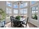 Bright dining room with large windows overlooking the backyard and a dark wooden table with six chairs at 199 Black Cloud Dr, Louisburg, NC 27549