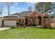Charming single story brick home with attached garage and manicured lawn at 199 Black Cloud Dr, Louisburg, NC 27549