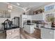 Modern kitchen with white cabinets, stainless steel appliances, a kitchen island, and hardwood floors at 199 Black Cloud Dr, Louisburg, NC 27549