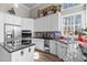 Well-lit kitchen featuring stainless steel appliances, granite countertops, and ample cabinet space at 199 Black Cloud Dr, Louisburg, NC 27549
