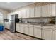 View of kitchenette, featuring light cabinets, a stainless steel fridge, and a window at 199 Black Cloud Dr, Louisburg, NC 27549