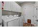 Laundry room featuring white Samsung washer and dryer set and overhead cabinets at 199 Black Cloud Dr, Louisburg, NC 27549