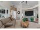 Comfortable living room with stone accent wall, TV, large sofa, and a view to a bedroom at 199 Black Cloud Dr, Louisburg, NC 27549
