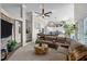 Spacious open-concept living room with a stone fireplace, large brown sofa and a view to the kitchen at 199 Black Cloud Dr, Louisburg, NC 27549