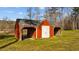 Red shed with covered storage on either side of the center at 199 Black Cloud Dr, Louisburg, NC 27549