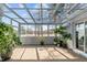 Relaxing sunroom filled with an array of lush plants and views of the outside at 199 Black Cloud Dr, Louisburg, NC 27549