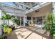 Sunroom filled with plants and a yellow chair at 199 Black Cloud Dr, Louisburg, NC 27549