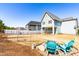 Spacious backyard with a well-manicured lawn, white fence, and a cozy seating area with chairs around a fire pit at 201 Bluffwood Avenue, Chapel Hill, NC 27516