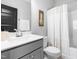 Bright bathroom featuring a gray vanity with a white countertop and a shower with a neutral shower curtain at 201 Bluffwood Avenue, Chapel Hill, NC 27516