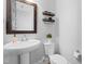 Clean and modern bathroom with a pedestal sink, sleek fixtures, and minimalist decor, creating a spa-like experience at 201 Bluffwood Avenue, Chapel Hill, NC 27516