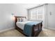 Comfortable bedroom with hardwood furniture, light-colored walls, and a bright window at 201 Bluffwood Avenue, Chapel Hill, NC 27516