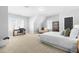 Spacious bedroom with neutral tones, natural light, and a cozy seating area, offering a serene retreat at 201 Bluffwood Avenue, Chapel Hill, NC 27516
