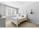 Serene bedroom featuring white furniture, neutral walls, carpet, and a bright window at 201 Bluffwood Avenue, Chapel Hill, NC 27516