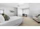 Large bedroom with neutral tones, desk, accent chair and plenty of natural light at 201 Bluffwood Avenue, Chapel Hill, NC 27516