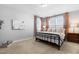 Cozy bedroom featuring a metal bed frame, neutral walls, carpet, and natural light from the window at 201 Bluffwood Avenue, Chapel Hill, NC 27516