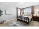 Cozy bedroom featuring a metal bed frame, neutral walls, carpet, and natural light from the window at 201 Bluffwood Avenue, Chapel Hill, NC 27516