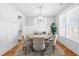 Sunlit dining room with round table, upholstered chairs, and large windows overlooking outdoor scenery at 201 Bluffwood Avenue, Chapel Hill, NC 27516