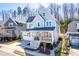 Inviting two-story home featuring a covered front porch and an attached garage with driveway at 201 Bluffwood Avenue, Chapel Hill, NC 27516