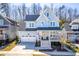 Charming light-blue two-story home featuring a welcoming front porch and attached two-car garage at 201 Bluffwood Avenue, Chapel Hill, NC 27516