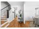 Open foyer featuring hardwood floors, a staircase, and an entryway into the dining room at 201 Bluffwood Avenue, Chapel Hill, NC 27516