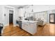 Stylish kitchen island with white cabinetry, stainless steel dishwasher, and a farmhouse sink at 201 Bluffwood Avenue, Chapel Hill, NC 27516