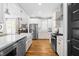 Modern kitchen with white cabinets, stainless steel appliances, and hardwood floors at 201 Bluffwood Avenue, Chapel Hill, NC 27516