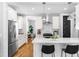 Bright kitchen features white cabinets, stainless steel appliances, and a center island with bar seating at 201 Bluffwood Avenue, Chapel Hill, NC 27516