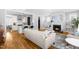 Open-concept living area with hardwood floors, a fireplace, comfortable sofa, and a seamless flow to the kitchen at 201 Bluffwood Avenue, Chapel Hill, NC 27516