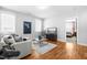 Inviting living room with hardwood floors, gray sectional sofa, and plenty of natural light at 201 Bluffwood Avenue, Chapel Hill, NC 27516