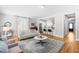 Open-concept living room seamlessly connects to the kitchen, featuring stylish furnishings and a cohesive design at 201 Bluffwood Avenue, Chapel Hill, NC 27516
