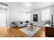 Comfortable living room with hardwood floors, a gray couch, and natural light at 201 Bluffwood Avenue, Chapel Hill, NC 27516
