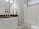 Bathroom featuring granite countertops, a shower-tub combo, and white cabinets, creating a clean and functional space at 201 Hales Wood Rd, Chapel Hill, NC 27517