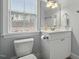 Charming bathroom featuring a white vanity, and a bright window, providing a functional and stylish space at 201 Hales Wood Rd, Chapel Hill, NC 27517