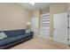 Comfortable bedroom with a blue sofa, built-in shelving, and natural light, perfect for relaxing or entertaining guests at 201 Hales Wood Rd, Chapel Hill, NC 27517