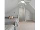 Light-filled bedroom with twin beds and angled ceilings, offering a unique and cozy living space at 201 Hales Wood Rd, Chapel Hill, NC 27517