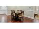 Dining room with dark wood table, seating for six, wood floors, and decorative chair backs at 201 Hales Wood Rd, Chapel Hill, NC 27517