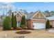 Charming single-story brick home with a two-car garage and manicured landscaping at 201 Hales Wood Rd, Chapel Hill, NC 27517