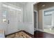 Bright foyer with hardwood floors, wainscoting and a view to the bathroom at 201 Hales Wood Rd, Chapel Hill, NC 27517