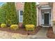 Inviting front entrance with a well-manicured garden and covered porch at 201 Hales Wood Rd, Chapel Hill, NC 27517