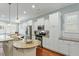 Bright kitchen with stainless appliances, white cabinets, granite counters, and eat-in bar at 201 Hales Wood Rd, Chapel Hill, NC 27517