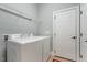 Efficient laundry room with modern washer and dryer, upper shelving, and ample storage space for laundry essentials at 201 Hales Wood Rd, Chapel Hill, NC 27517