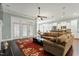 Open-concept living room with hardwood floors, plush seating, and lots of natural light at 201 Hales Wood Rd, Chapel Hill, NC 27517
