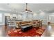 Open-concept living room with kitchen, dining area, and lots of natural light at 201 Hales Wood Rd, Chapel Hill, NC 27517