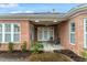Comfortable patio featuring two chairs, a ceiling fan, and beautiful brick work at 201 Hales Wood Rd, Chapel Hill, NC 27517